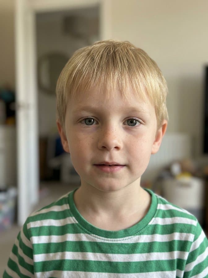 Photo of Bo, an invented child with short fair hair and freckles, made with AI